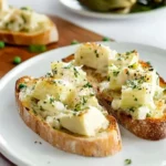 Artichoke Bruschetta with creamy artichoke cheese topping on toasted baguette slices