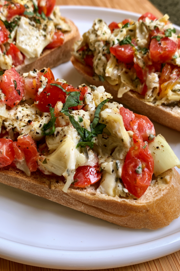 Artichoke Bruschetta with creamy artichoke cheese topping on toasted baguette slices